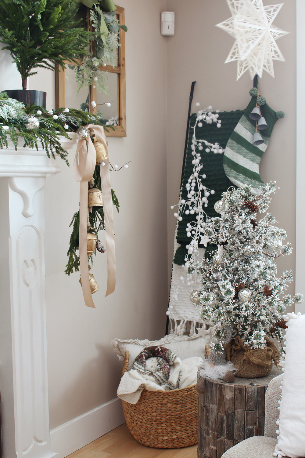 Blanket ladder in a green and white Christmas living room.
